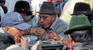 Men eating lunch in an Andean market